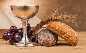 holy communion chalice on wooden table