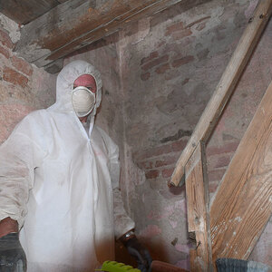 Schwerarbeit mit Maske und Schutzanzug im Turm