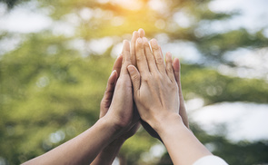 Teamwork high five as team together hands air greeting  power tag team. Group of diversity people multiethnic