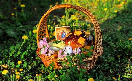 Easter basket on the grass with dandelion background