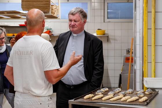 Festgottesdienst und Junia-Fest unter der Eisenbahnbrücke mit Bischof Manfred Scheuer / © Diözese Linz / Johannes Kienberger Bischof Manfred Scheuer mit Mitarbeiter Toni Pichler.