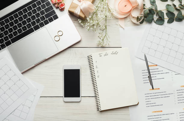 Wedding to do list top view. Present boxes, calendar for marriage planning and various bridal stuff on white rustic table. Memmorable date organization background