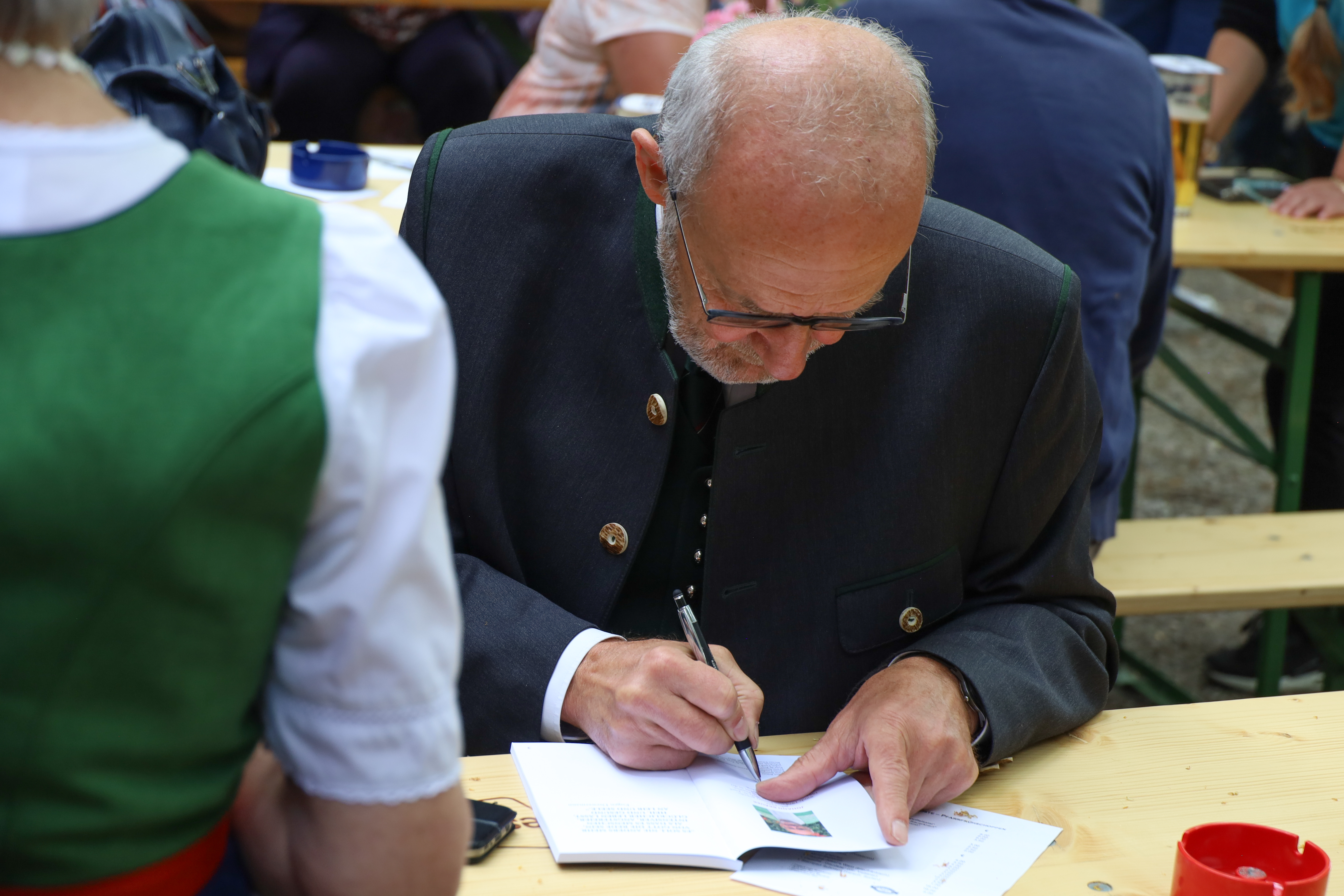 Pfarrmoderator Johann Bräuer beim Signieren.