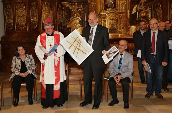Wilhelm Vieböck mit dem künstlerischen Baustein und der Sakralkunst-Publikation, Geschenke der Diözese Linz