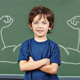 Strong child with muscles drawn on chalkboard in elementary school