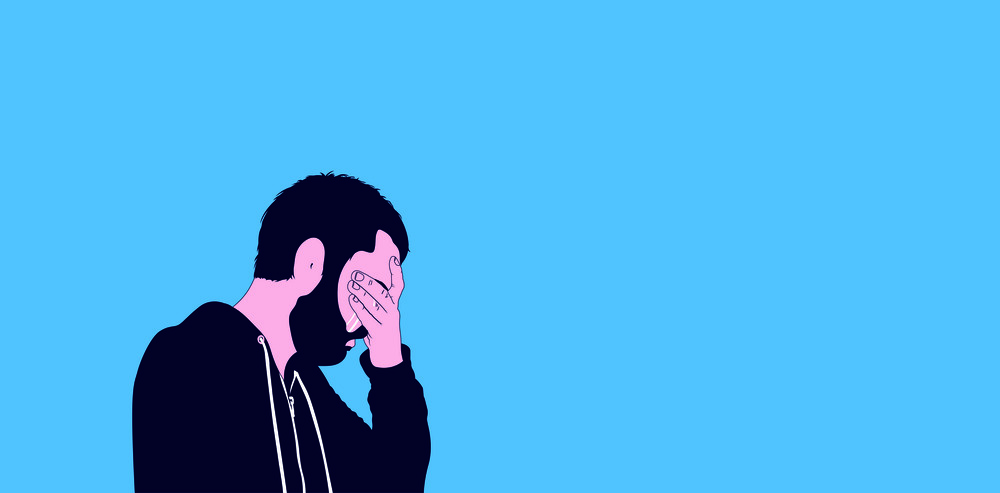 Ein Mann hält sich die Hand vor das Gesicht