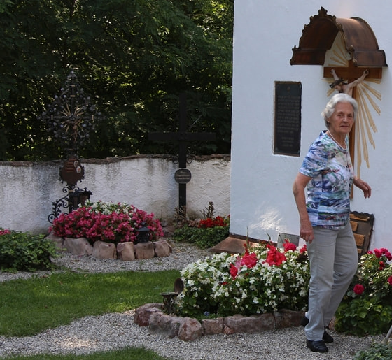 Maria Dammer beim Grab ihrer Eltern Franz und Franziska Jägerstätter in St. Radegund