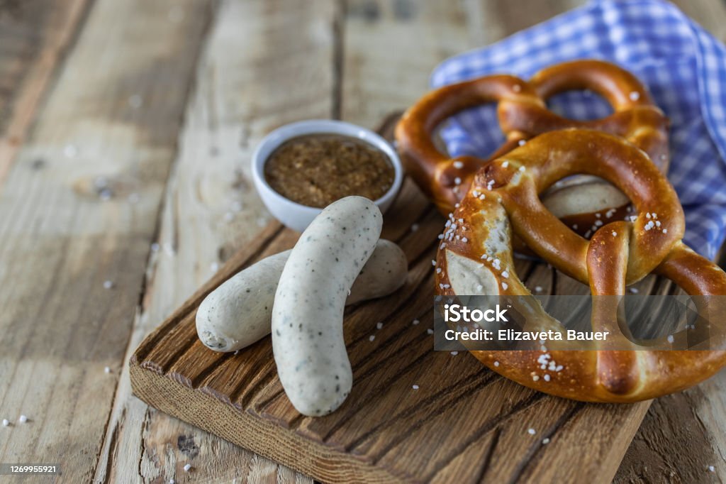 Beer Fest food. Bavarian meal . White sausages, brezel and sweet mustard on wooden table